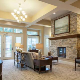 A modern living room with a stone fireplace and elegant decor.