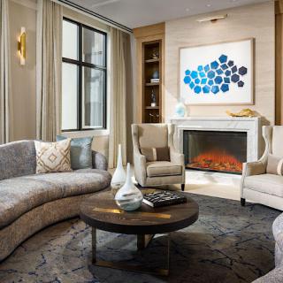 A stylish and cozy living room with a fireplace, featuring comfortable seating and modern decor.