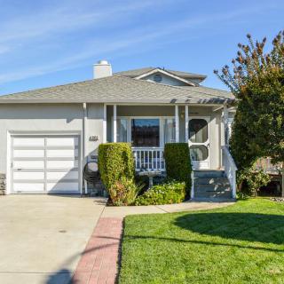 A suburban house with a well-maintained front yard and driveway.