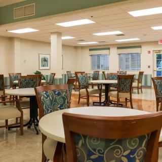 An empty dining area with neatly arranged tables and chairs.