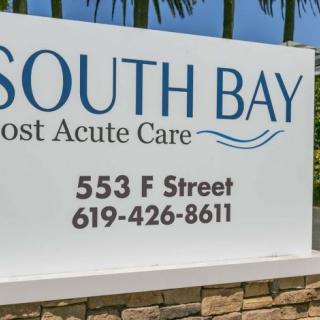A sign for South Bay Post Acute Care displaying the address and contact number.
