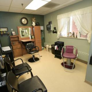 A cozy hair salon interior with styling chairs and mirrors.
