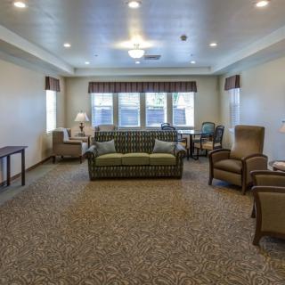 A spacious living room with comfortable seating and large windows.