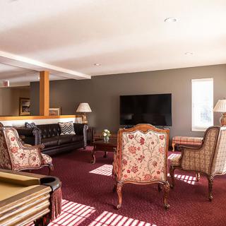 A cozy living room with elegant furniture and a large television.