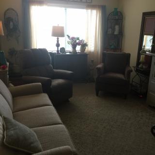 A cozy living room with comfortable seating and natural light.