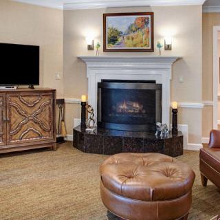 A cozy living room featuring a fireplace, comfortable seating, and decorative accents.