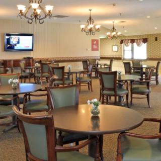 Spacious dining area with elegant furniture and lighting fixtures.