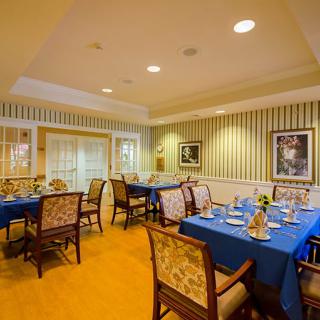 A cozy dining area with elegantly set tables and classic decor.