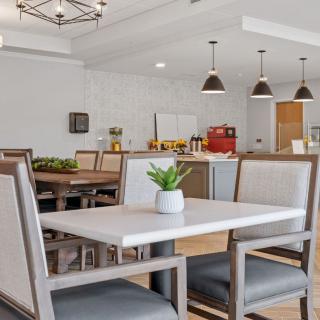 A modern dining area with stylish furniture and ambient lighting.