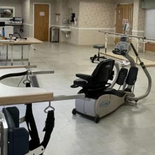A rehabilitation room equipped with exercise and therapy equipment.