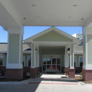 Front entrance of a residential building with columns.