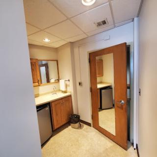 A well-lit bathroom featuring wooden cabinetry and a contemporary design.