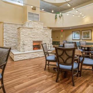 A cozy indoor seating area with a fireplace and wooden floors.