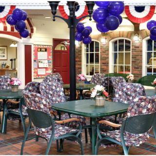 A festive indoor cafe setting adorned with balloons and patriotic decorations.