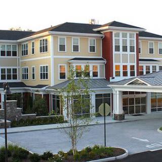 A modern residential building with a well-landscaped entrance.