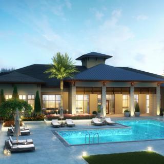 A luxurious modern house with a beautifully lit swimming pool and surrounding palm trees at dusk.
