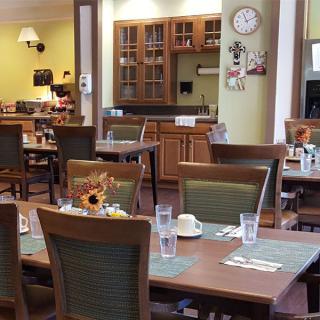 Cozy dining area with neatly set tables and warm decor.