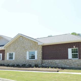 A modern residential building with a combination of stone and brick exterior.