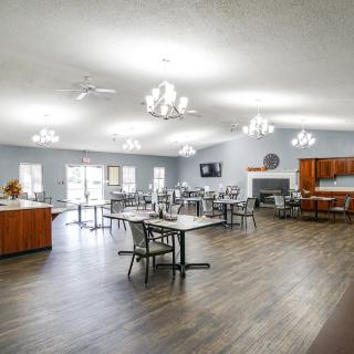 Spacious dining hall with multiple tables and chandeliers.