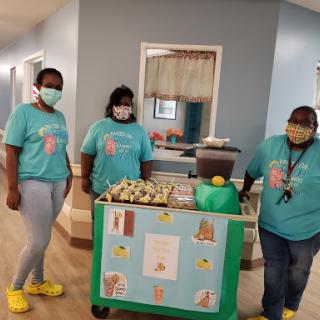 Dedicated staff members providing food service in a healthcare setting.