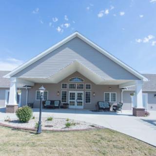 A residential building with a prominent entrance under a clear sky.