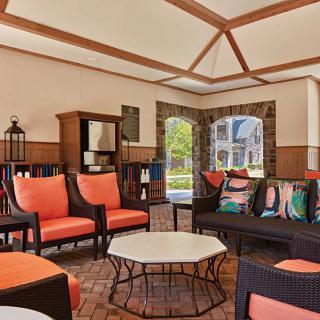 A cozy lounge area with comfortable seating and large windows allowing natural light.