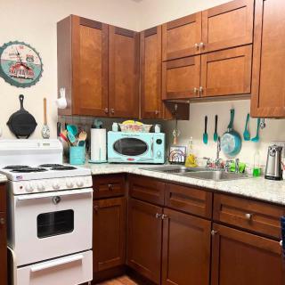 A cozy kitchen with wooden cabinets and retro-style appliances.