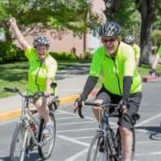 A group of cyclists in bright shirts enjoying a ride outdoors.