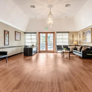 A spacious and elegantly designed living room featuring stylish furniture and abundant natural light.