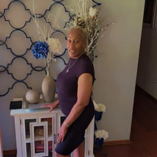 A woman posing gracefully in a beautifully decorated indoor space.