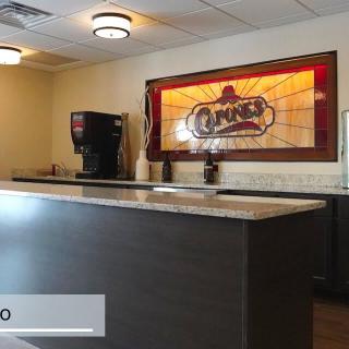 A hotel reception area featuring a counter and decorative lighting.