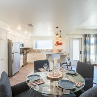 A modern open-concept kitchen and dining area with stylish furnishings and decor.