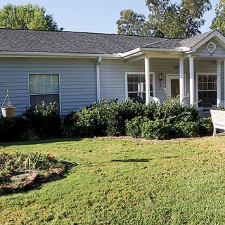 A suburban house with a well-maintained lawn and garden.