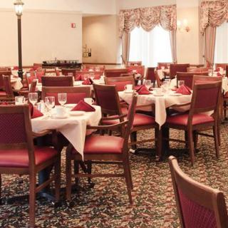 A well-decorated restaurant dining area with neatly arranged tables and chairs.
