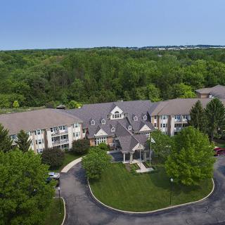 Aerial view of a residential building surrounded by lush greenery.