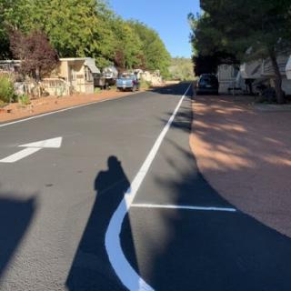A sunny day on a quiet street with a clear directional arrow.