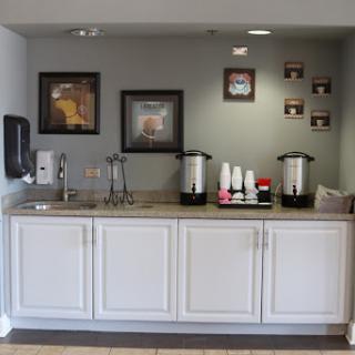 A cozy breakfast area featuring a coffee station and decorative wall art.