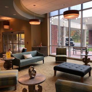 A modern lobby with comfortable seating and large windows.