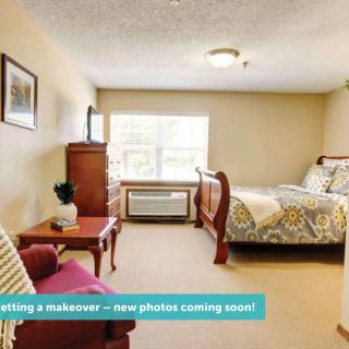 Comfortable and cozy bedroom with classic furniture, awaiting a makeover.
