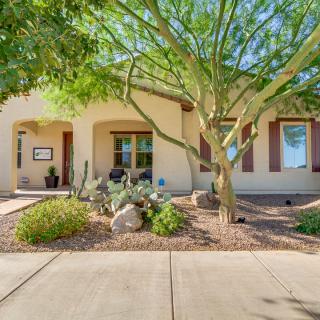 A charming house with a desert landscape front yard featuring succulents and a large tree.
