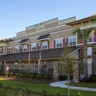 A modern residential building with a landscaped exterior and contemporary architectural design.