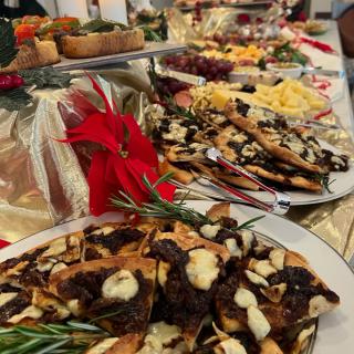 A festive buffet spread featuring a variety of desserts and holiday-themed decorations.