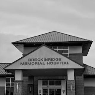 Exterior view of Breckinridge Memorial Hospital in black and white.