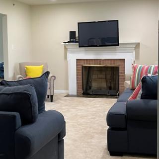 A cozy living room featuring a fireplace, television, and comfortable seating.