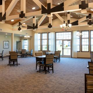 Spacious dining area with vaulted ceilings and large windows.