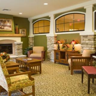 A cozy living room featuring a fireplace, comfortable seating, and decorative elements.
