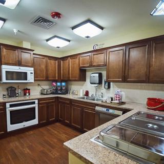 A modern kitchen with wooden cabinets and built-in appliances.