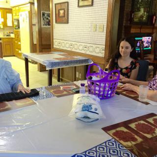 A group of people sitting around a table in a cozy dining area.