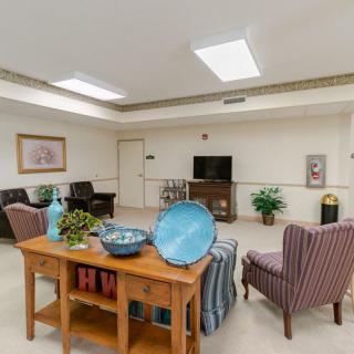 A cozy living room with comfortable seating, a television, and decorative elements.
