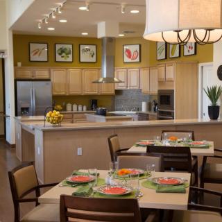 A modern kitchen and dining area with stylish decor and a neatly set table.